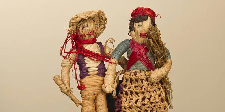 Two dolls stitched together, a man and a woman.
